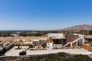 an aerial view of a house with mountains in the background at Stone Waves Αpartments & Villas in Agios Arsenios +70 photos