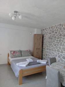 a bedroom with a bed and a table and chairs at Anastasija & Tara in Ðuraševići