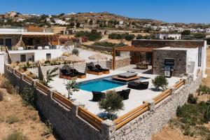 an aerial view of a villa with a swimming pool at Stone Waves Αpartments & Villas in Agios Arsenios