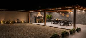 a patio with a table and chairs and a fireplace at Harmony apartment near Dassia, Ipsos in Ipsos