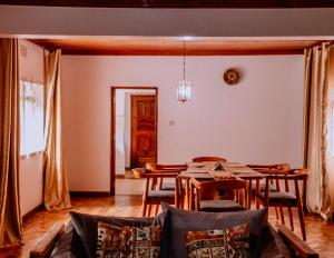 a living room with a table and a dining room at Avana Home in Arusha