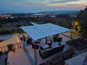 an overhead view of a patio with a blue roof at Apartmani SUNSET in Rab