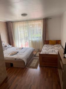 a bedroom with two beds and a window at Cabana Andre Vartop in Vartop +9 photos