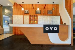 a restaurant counter with a sign that reads oxo at Hotel O by OYO REFRESH INN & SUITES in Kozhikode +23 photos