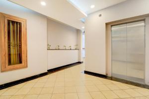 a hallway with a large glass door in a building at Hotel O by OYO REFRESH INN & SUITES in Kozhikode