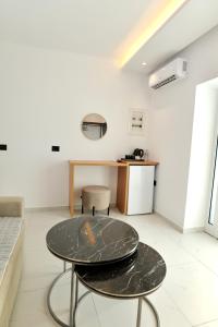 a table and two chairs in a room at Abelia Hotel in Ksamil