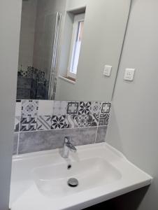 a bathroom with a sink and a mirror at Gîte Le Mansois in Marcillac-Vallon +10 photos
