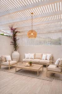 a living room with a couch and a table at Villa Almihauss - Adults Only in Afantou