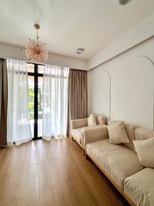a living room with a couch and a large window at Sosun View Private Villa in Thoddoo