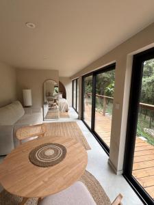 a living room with a table and a couch at Domaine d'Olga - Lodges & SPA in Aniane