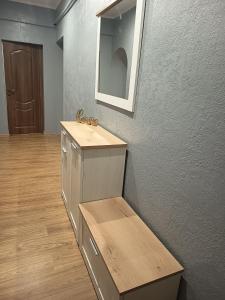 a bathroom with a sink and a mirror on a wall at Comfort place in Ternopil +2 photos