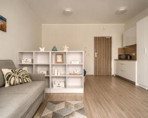 a living room with a couch and a kitchen at Apartament typu studio Doris 3 - 50m od plaży in Pobierowo