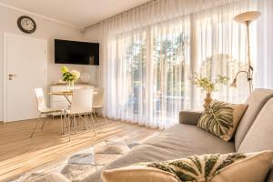 a living room with a couch and a table at Apartament typu studio Doris 3 - 50m od plaży in Pobierowo