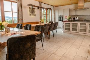a kitchen and dining room with a table and chairs at 5 Sterne Holzchalet Dienberger Hof in Untergriesbach