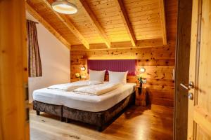 a bedroom with a bed in a wooden room at 5 Sterne Holzchalet Dienberger Hof in Untergriesbach +22 photos
