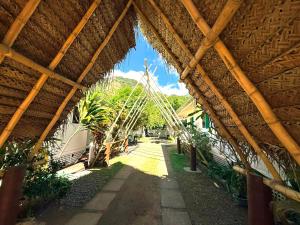 a view of a building with a bamboo roof at Secret Spot Lagoon Dream in Moorea