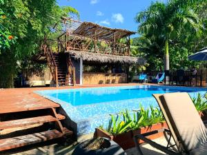a swimming pool in front of a house with a resort at Secret Spot Lagoon Dream in Moorea