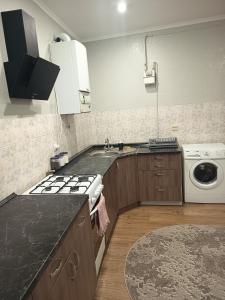 a kitchen with a sink and a stove top oven at Comfort place in Ternopil