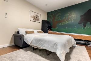 a bedroom with a bed and a large painting on the wall at NEW HOT TUB Game Room Firepit Near Windham in Prattsville