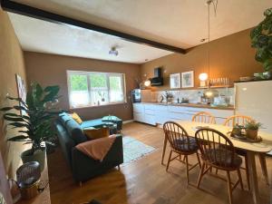 a living room with a couch and a table at Kochstedter Wohnstuben - Fewo mit Naturbaustoffen in der Bauhausstadt Dessau - hundefreundlich - ebenerdig - mit Garten - Parkplatz inklusive in Dessau