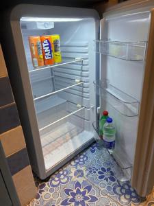 an open refrigerator with its door open with drinks in it at Vic e Vicariell in Gaeta