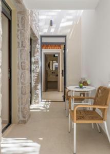 a hallway with tables and chairs in a building at Zefyria Luxury Suites in Zefiría