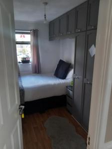 a small bedroom with a bed and a window at Divis street guest house in Belfast +9 photos