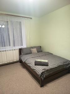 a bedroom with a bed and a window at Comfort place in Ternopil