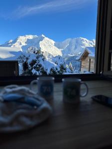 a view of a snowy mountain from a window at Le Chalet Remy in Saint-Gervais-les-Bains +1 photo