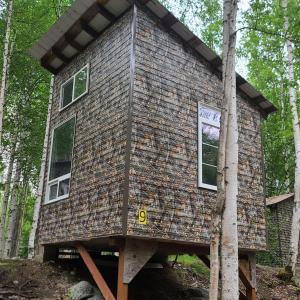 a tree house in the woods at Adventure Trail Cabin #9 in Houston