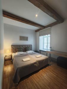a bedroom with a large bed with two towels on it at Tallinn Residence 1937 in Tallinn