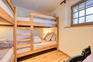 two bunk beds in a room with a window at Le Chalet Remy in Saint-Gervais-les-Bains