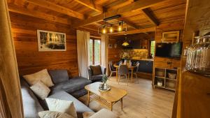 a living room and kitchen in a log cabin at Chatka Wald in Kostrzyca
