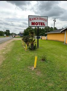 a sign for a ranch house motel on the side of a road at Ranch House Motel in Marksville