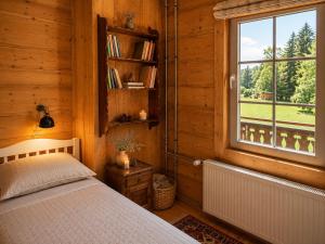a bedroom with a bed and a window at Riversong Centre Thermal in Les Plans-sur-Bex