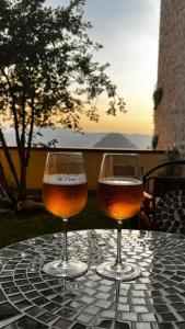 two glasses of beer sitting on a table at San Leo Albergo Diffuso in San Leo