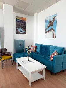 a living room with a blue couch and a coffee table at Peron in Nikšić