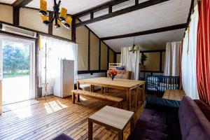 a living room with a table and a couch at Pie lacuksa in Tīnūži
