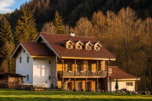 a large white house with a brown roof at Riversong Centre Thermal in Les Plans-sur-Bex