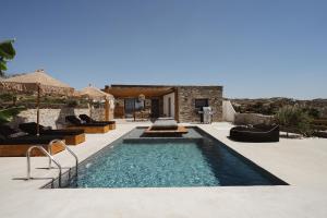 a pool in the backyard of a house at Stone Waves Αpartments & Villas in Agios Arsenios