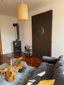 a living room with a couch and a wood stove at Kaminzimmer in Trebbin