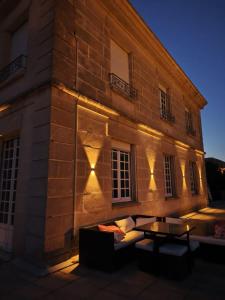a building with lights on the side of it at Chambres d hôtes dans maison bourgeoise Douce France in Millau