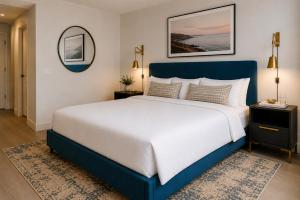 a large bed with a blue headboard in a bedroom at Bluebird Suites at Georgetown in Washington, D.C.