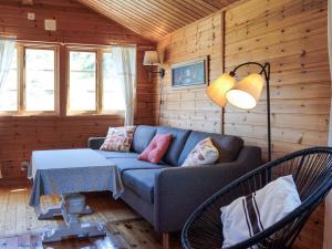 a living room with a blue couch and a table at 4 person holiday home in Strömstad in Strömstad