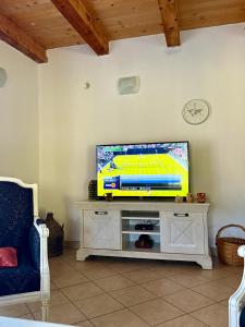 a living room with a flat screen tv on a stand at Milovan in Cetinje