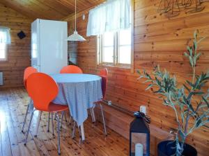 a dining room with a table and orange chairs at 4 person holiday home in Strömstad in Strömstad