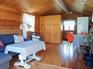 a living room with a blue couch and a table at 4 person holiday home in Strömstad in Strömstad