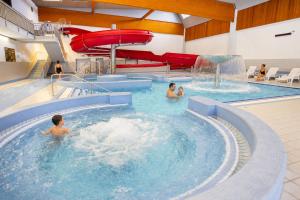 a group of people in a swimming pool at Hotel CHODOV ASC in Prague