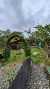 a wooden bridge with a arch in a park at Cabaña Vista de Oro 2 in Paraíso