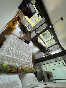 an overhead view of a bedroom with a bed and a tv at Solar das Aroeiras in Serra do Cipo